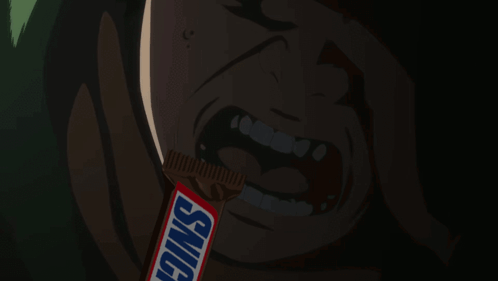 Man Eating Snickers Bar in Dark Room