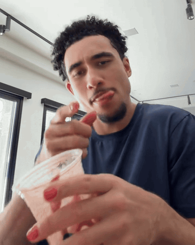 Man Eating Strawberry from Cup