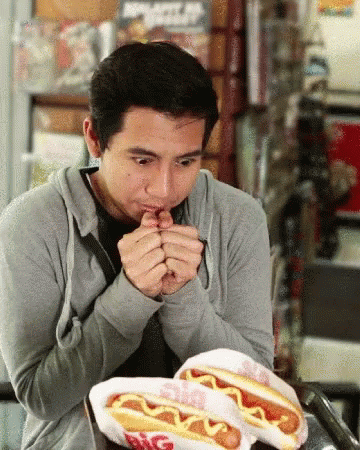 Man Eating Two Hot Dogs With Mustard Big Boy GIF