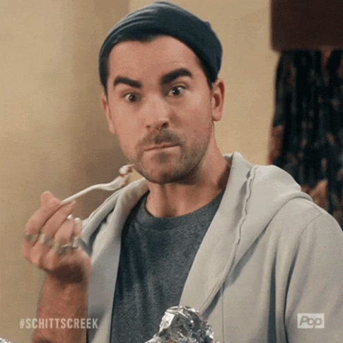 Man Eating With Spoon Wearing Schittscreek Shirt GIF