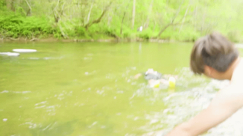 Man Fishing While Another Man Swimming