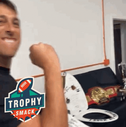 Man Flexing Arm With Trophy Smack Logo GIF