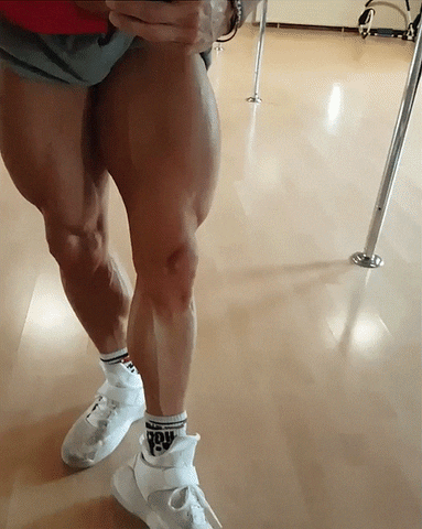Man Flexing Muscle Growth In His Legs GIF