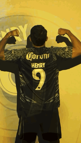 Man Flexing Muscles in Front of Henry Sign
