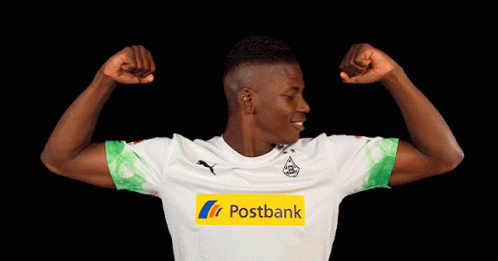 Man Flexing Muscles In Postbank Jersey GIF