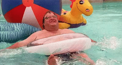 Man Floating in Pool on Raft
