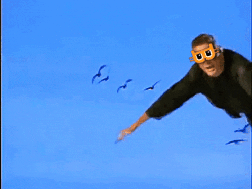 Man Flying in Blue Sky with B Mask