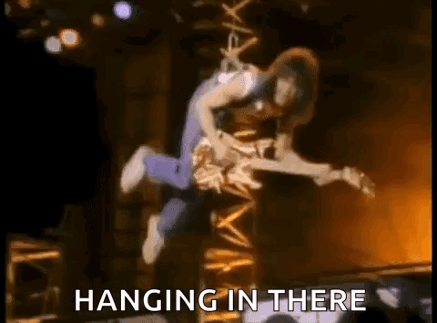 Man Flying with Guitar Hanging In There