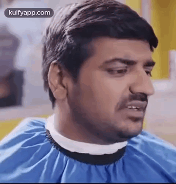 Man Getting Haircut By Barber In Blue Cape GIF