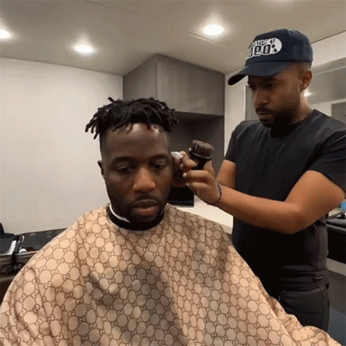 Man Getting Haircut By Man With 100% Hat GIF