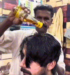 Man Getting Haircut From Bearded Man