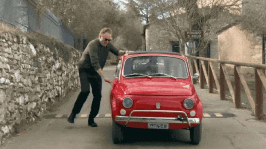 Man Getting Into A Small Fast Car GIF