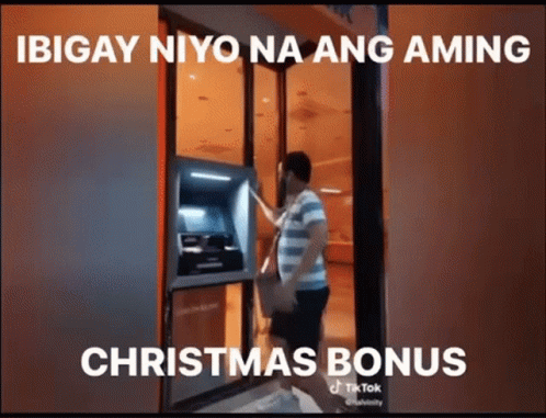 Man Getting Money From ATM With Christmas Bonus Caption