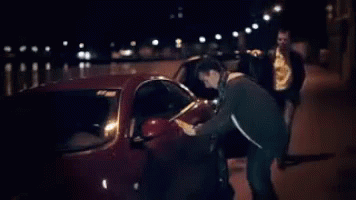 Man Getting Out of Car at Night