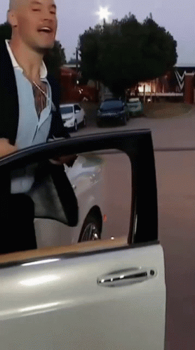 Man Getting Out of Car With Door Open
