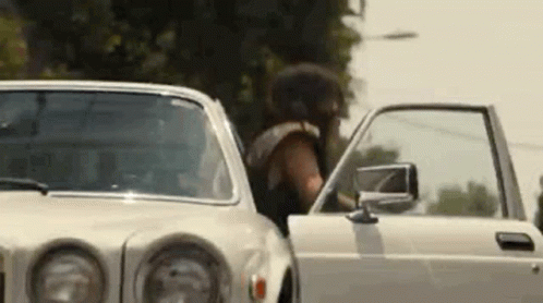 Man Getting Out of White Car Door Open