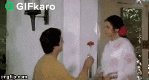 Man Giving Flower To Woman GIF