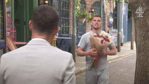 Man Giving Flowers Aggressively GIF