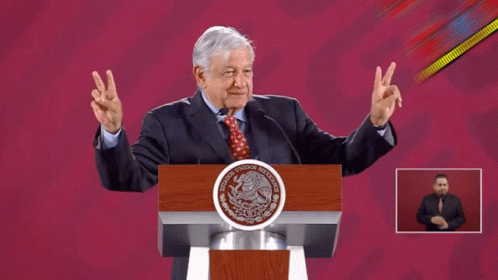 Man Giving Peace Sign at Mexico Podium