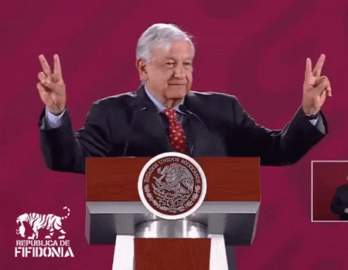 Man Giving Peace Sign At Republica De Fifidonia Podium GIF