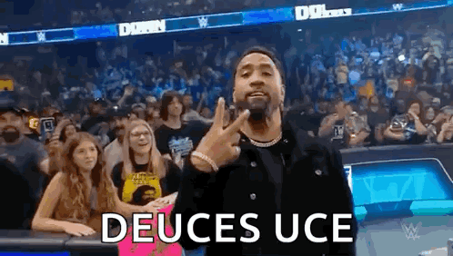Man Giving Peace Sign In Front Of Crowd GIF