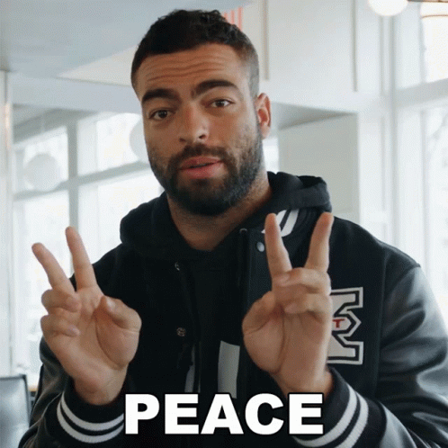 Man Giving Peace Sign Saying Peace