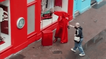 Man Giving Printed Umbrellas To People GIF