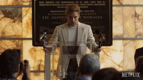 Man Giving Speech at Podium with Netflix Logo