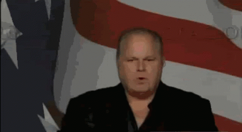 Man Giving Speech In Front Of Flag GIF