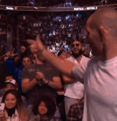 Man Giving Thumbs Up at Sports Event