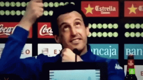 Man Giving Thumbs Up in Front of Coca Cola Sign
