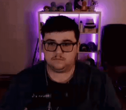 Man Glasses Headphones at Microphone in Purple Lights