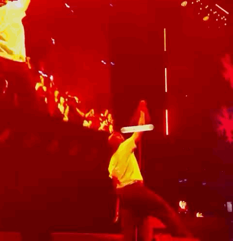 Man Hanging From Rope on Stage