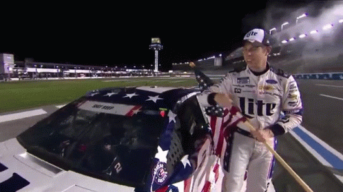 Man Holding American Flag Near Car Saying Lite