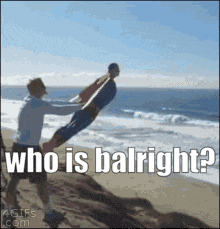 Man Holding Another Man On Beach Saying Who Is Balright GIF