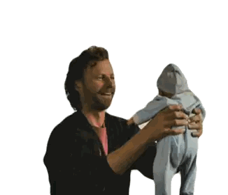 Man Holding Baby and Smiling