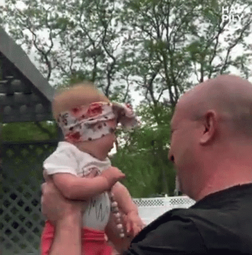 Man Holding Baby Girl With Headband