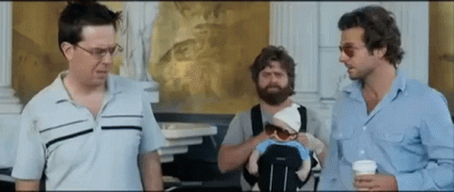 Man Holding Baby in Stroller