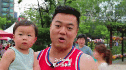 Man Holding Baby with Go Canada Shirt