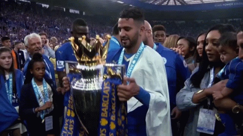 Man Holding Barclay's Trophy