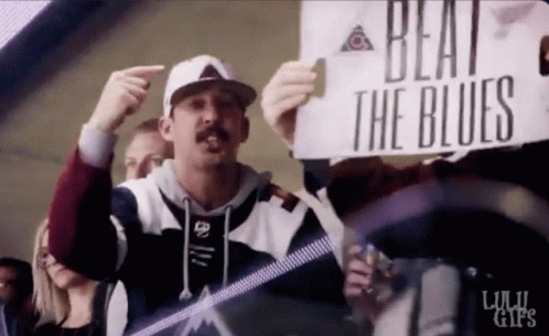 Man Holding Beat the Blues Sign