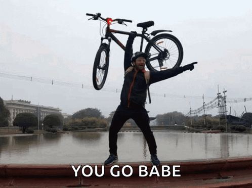 Man Holding Bicycle Overhead Saying You Go Babe GIF
