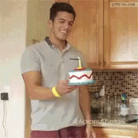 Man Holding Birthday Cake with Candle