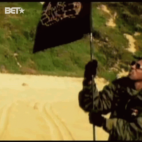 Man Holding Black Flag With BET Logo GIF