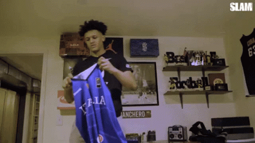 Man Holding Blue T.LA Shirt GIF