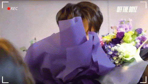 Man Holding Bouquet of Flowers
