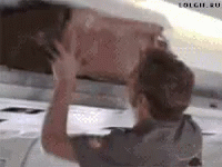 Man Holding Box Under Plane