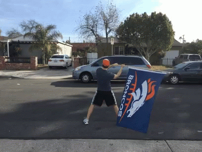 Man Holding Broncos Flag In Front Of Car GIF
