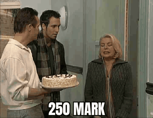 Man Holding Cake for Woman, Another Man Watching