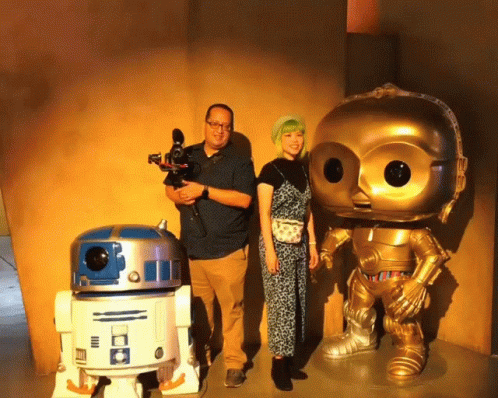 Man Holding Camera Next to R2D2